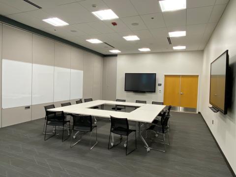 Program Room B large room two display tvs tables and chairs